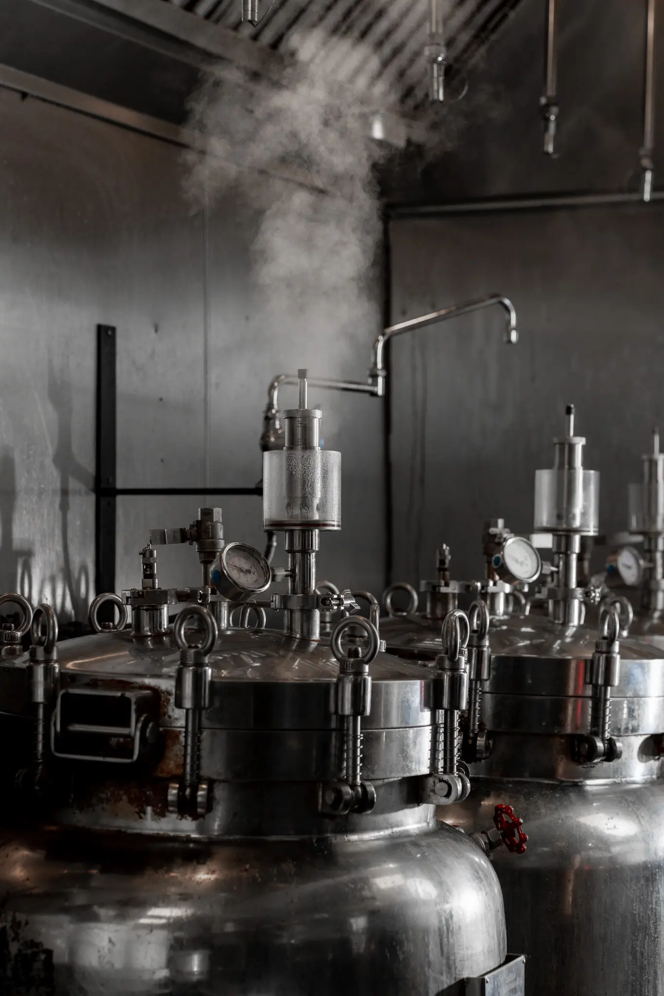 A column of steam rising from a broth vessel inside the Tajima commissary kitchen
