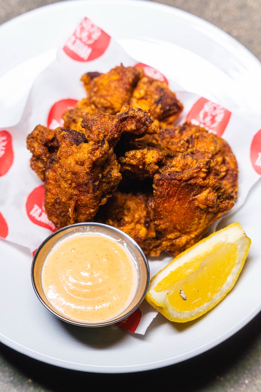 A plate of karaage, seasoned deep-fried Japanese chicken, with mayonnaise and lemon